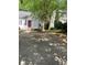 A single Gathering house shows a spacious paved driveway and a large tree in the front yard for curb appeal at 1047 Plantation Way, Kennesaw, GA 30301
