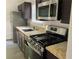 Galley kitchen offers stainless steel appliances, granite countertops, and brown cabinetry at 1047 Plantation Way, Kennesaw, GA 30301