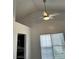 Living room featuring vaulted ceilings, ceiling fan and large windows at 1047 Plantation Way, Kennesaw, GA 30301
