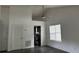 Bright living room with vaulted ceilings, ceiling fan, hardwood floors, and view of kitchen at 1047 Plantation Way, Kennesaw, GA 30301