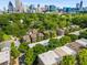 Aerial view showcasing homes surrounded by lush greenery, with the city skyline in the background at 396 15Th Nw St # 6, Atlanta, GA 30318