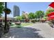 Relaxing outdoor area with tables, umbrellas, and lush greenery, perfect for enjoying the surroundings at 396 15Th Nw St # 6, Atlanta, GA 30318