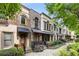 Elegant townhome exteriors with manicured landscaping, stone accents, and arched windows at 396 15Th Nw St # 6, Atlanta, GA 30318