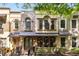 Charming townhome with brick and stucco facade, arched windows, and metal awnings at 396 15Th Nw St # 6, Atlanta, GA 30318
