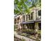 Elegant townhome exterior with manicured landscaping and arched windows at 396 15Th Nw St # 6, Atlanta, GA 30318