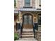 Inviting double front door with brick steps, black railings, and stylish outdoor lighting at 396 15Th Nw St # 6, Atlanta, GA 30318