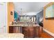 Spacious kitchen featuring granite countertops, stainless steel appliances, a breakfast bar, and dark wood cabinets at 396 15Th Nw St # 6, Atlanta, GA 30318