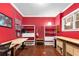 Bright office space with a red accent wall, hardwood floors, and a built-in shelving system at 396 15Th Nw St # 6, Atlanta, GA 30318
