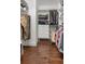 Well-organized walk-in closet featuring built-in shelving, drawers, and wood flooring at 396 15Th Nw St # 6, Atlanta, GA 30318