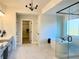 Bathroom features a soaking tub, glass shower, modern fixtures and marble tile floors at 4020 Sierra Knolls Ct, Cumming, GA 30040