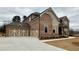Stunning brick home featuring a spacious three-car garage and professionally landscaped yard at 4020 Sierra Knolls Ct, Cumming, GA 30040