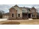 Charming two-story brick home with a meticulously landscaped front yard and a three-car garage at 4020 Sierra Knolls Ct, Cumming, GA 30040