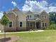 Beautiful brick two-story home featuring a manicured lawn and a welcoming front porch at 4020 Sierra Knolls Ct, Cumming, GA 30040