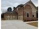 Spacious three-car garage with stylish carriage doors, and a large concrete driveway at 4020 Sierra Knolls Ct, Cumming, GA 30040