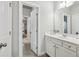 Bathroom featuring white vanity with open doorway leading to bedroom at 5180 Mirror Lake Dr, Cumming, GA 30028