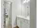 Neutral bathroom with white vanity and an open doorway leading to the bedroom at 5180 Mirror Lake Dr, Cumming, GA 30028