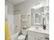 Bright bathroom featuring a shower and tub combo, a white vanity, and neutral walls at 5180 Mirror Lake Dr, Cumming, GA 30028