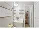 Bright bathroom featuring a white vanity, decorative shelves, and decor at 5180 Mirror Lake Dr, Cumming, GA 30028