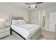Serene bedroom with a stylish bed, neutral decor, and a doorway leading to the bathroom at 5180 Mirror Lake Dr, Cumming, GA 30028