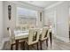 Bright dining room with a modern table and chairs, complemented by a window view at 5180 Mirror Lake Dr, Cumming, GA 30028