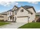 Charming two-story brick home with a well-manicured lawn and attached two-car garage at 5180 Mirror Lake Dr, Cumming, GA 30028