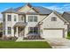 Charming two-story brick home with a well-manicured lawn and attached two-car garage at 5180 Mirror Lake Dr, Cumming, GA 30028