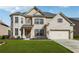 Charming two-story brick home with a well-manicured lawn and attached two-car garage at 5180 Mirror Lake Dr, Cumming, GA 30028