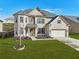 Charming home featuring a well-kept lawn, brick facade, and inviting entrance, set in a peaceful neighborhood setting at 5180 Mirror Lake Dr, Cumming, GA 30028