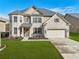 Stunning two-story home with brick and stone accents, manicured lawn, and attached two-car garage, offering curb appeal at 5180 Mirror Lake Dr, Cumming, GA 30028