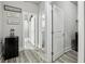 Hallway featuring sleek floors, neutral tones, and various rooms including a bathroom and laundry at 5180 Mirror Lake Dr, Cumming, GA 30028