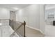 Upstairs hallway with wood railing and a view to the Primary suite bedroom at 5180 Mirror Lake Dr, Cumming, GA 30028