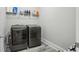 Laundry room featuring sleek floors, neutral tones, and new model washer and dryer at 5180 Mirror Lake Dr, Cumming, GA 30028
