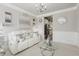 Stylish living room featuring elegant decor, comfortable white seating, and access to the kitchen, perfect for entertaining at 5180 Mirror Lake Dr, Cumming, GA 30028