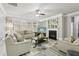 Bright living room featuring a fireplace, ceiling fan, and neutral color scheme at 5180 Mirror Lake Dr, Cumming, GA 30028