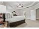 Spacious main bedroom with tray ceiling and view to the modern bathroom at 5180 Mirror Lake Dr, Cumming, GA 30028