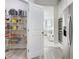 Walk-in pantry with wire shelving, a view to the living room, and stainless steel appliances at 5180 Mirror Lake Dr, Cumming, GA 30028
