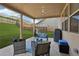 Covered patio featuring comfortable seating, a ceiling fan, and views of the fenced backyard at 5180 Mirror Lake Dr, Cumming, GA 30028