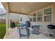 Covered patio featuring comfortable seating, a ceiling fan, and views of the fenced backyard at 5180 Mirror Lake Dr, Cumming, GA 30028