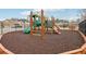 Community playground area with safe mulch ground cover and modern play equipment at 5180 Mirror Lake Dr, Cumming, GA 30028