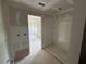 Unfinished bathroom featuring a shower unit and an open doorway to an adjacent, unfinished room at 1006 Starmoss Lane, Conyers, GA 30094