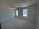 Well-lit bedroom with two windows offering outdoor views, ready for your personal touch at 1006 Starmoss Lane, Conyers, GA 30094