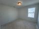 Bright bedroom features a window and neutral walls, awaiting personalization and decor at 1006 Starmoss Lane, Conyers, GA 30094