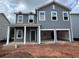 Two-story home with gray siding, white trim, a covered porch, and an attached two-car garage at 1006 Starmoss Lane, Conyers, GA 30094