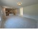 Open-concept living room with a view into the kitchen, providing ample space for relaxation and entertainment at 1006 Starmoss Lane, Conyers, GA 30094