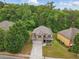 Aerial view of a charming home with a well-maintained yard and a backdrop of lush greenery at 11028 Southwood Dr, Hampton, GA 30228