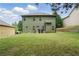 Large grassy backyard with rear exterior view of home at 11028 Southwood Dr, Hampton, GA 30228