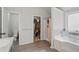 Bright bathroom featuring a separate shower and soaking tub and a large walk-in closet at 11028 Southwood Dr, Hampton, GA 30228