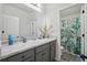 Bathroom with gray cabinets, neutral walls, and a separate toilet and shower areas at 11028 Southwood Dr, Hampton, GA 30228
