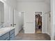 Bright bathroom featuring a separate shower and soaking tub and a large walk-in closet at 11028 Southwood Dr, Hampton, GA 30228