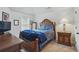 Well-lit bedroom with wood-look furniture set, window with natural light, and carpet flooring at 11028 Southwood Dr, Hampton, GA 30228